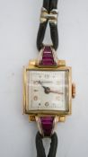A Bucherer Art Deco gold plated ladies cocktail watch, set with pink paste baguette stones, square