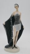 An Art Deco style resin figure of a flapper girl with black shawl and beaded skirt. H.37 x W.15 x
