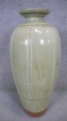 RICHARD BATTERHAM (1936-2021)- A tall terracotta bottle vase covered in green ash glaze and vertical