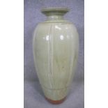 RICHARD BATTERHAM (1936-2021)- A tall terracotta bottle vase covered in green ash glaze and vertical