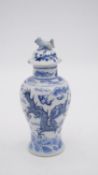 A Chinese blue and white lidded porcelain vase with dragon design and four character mark to base.