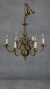 A Dutch style brass eight branch chandelier with scrolling design. H.66 D.70