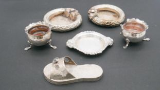 A collection of silver items. Including a silver sandal with engraved detailing, two foliate