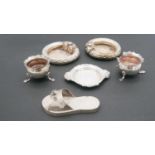 A collection of silver items. Including a silver sandal with engraved detailing, two foliate