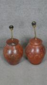Two floral engraved terracotta effect ceramic table lamps with brass fittings. H.56CM