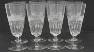 A set of eight Victorian cut glass wine glasses with petal faceting and linear design. H. 15 Diam.