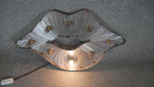 A light up metal wall sign in the form of a pair of lips. H.45 W.75CM