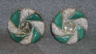 Two relief ceramic plaques with gilded and emerald green decoration and classical medallion to the
