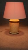 A John Lewis paper effect ceramic cylindrical table lamp with calligraphy and gilded details. Makers