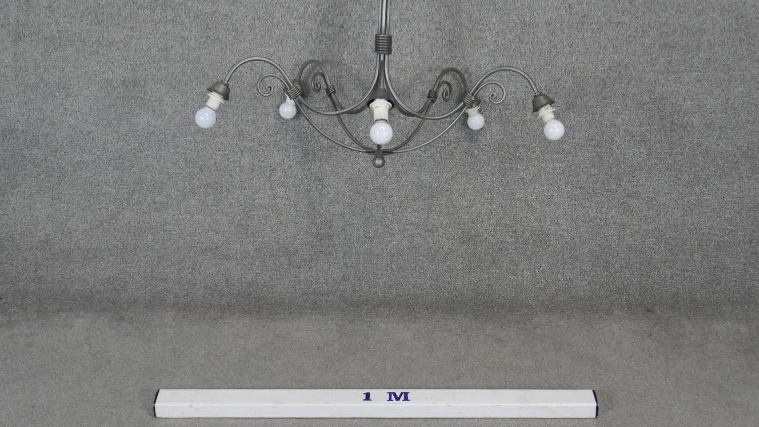 A wrought metal five branch chandelier with scrolling arms. Dia.90cm - Image 2 of 4