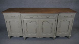 A French Provincial style sideboard with crossbanded oak top above painted base on squat cabriole