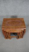 A nest of four Eastern teak graduating occasional tables with carved tops and floral brass inlay