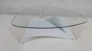 A contemporary coffee table with plate glass top on a shaped metal tripod base. H.36 x D.105cm