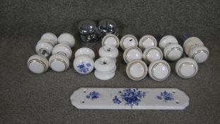 A collection of vintage and antique ceramic doorknobs and door plates. Some decorated with a blue