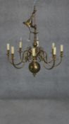 A Dutch style brass eight branch chandelier with scrolling design. H.70 D.90cm