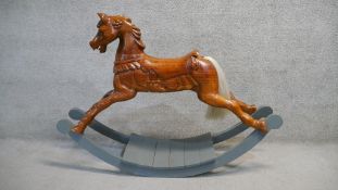 A contemporary Victorian style pitch pine rocking horse of traditional construction on painted