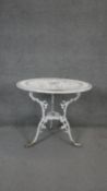 A white painted wrought metal garden table. H.70 D.80