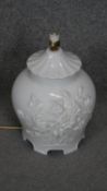 A white glazed ceramic relief floral design table lamp. H.35CM