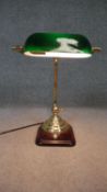 A brass bankers desk lamp with green glass adjustable shade, mounted on a wooden base. Working. H.40