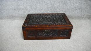 An Eastern carved and inlaid hinged lidded box. H. 17 W. 47 D. 30