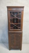 A Georgian style mahogany corner cabinet with astragal glazed display section above panel door. H.