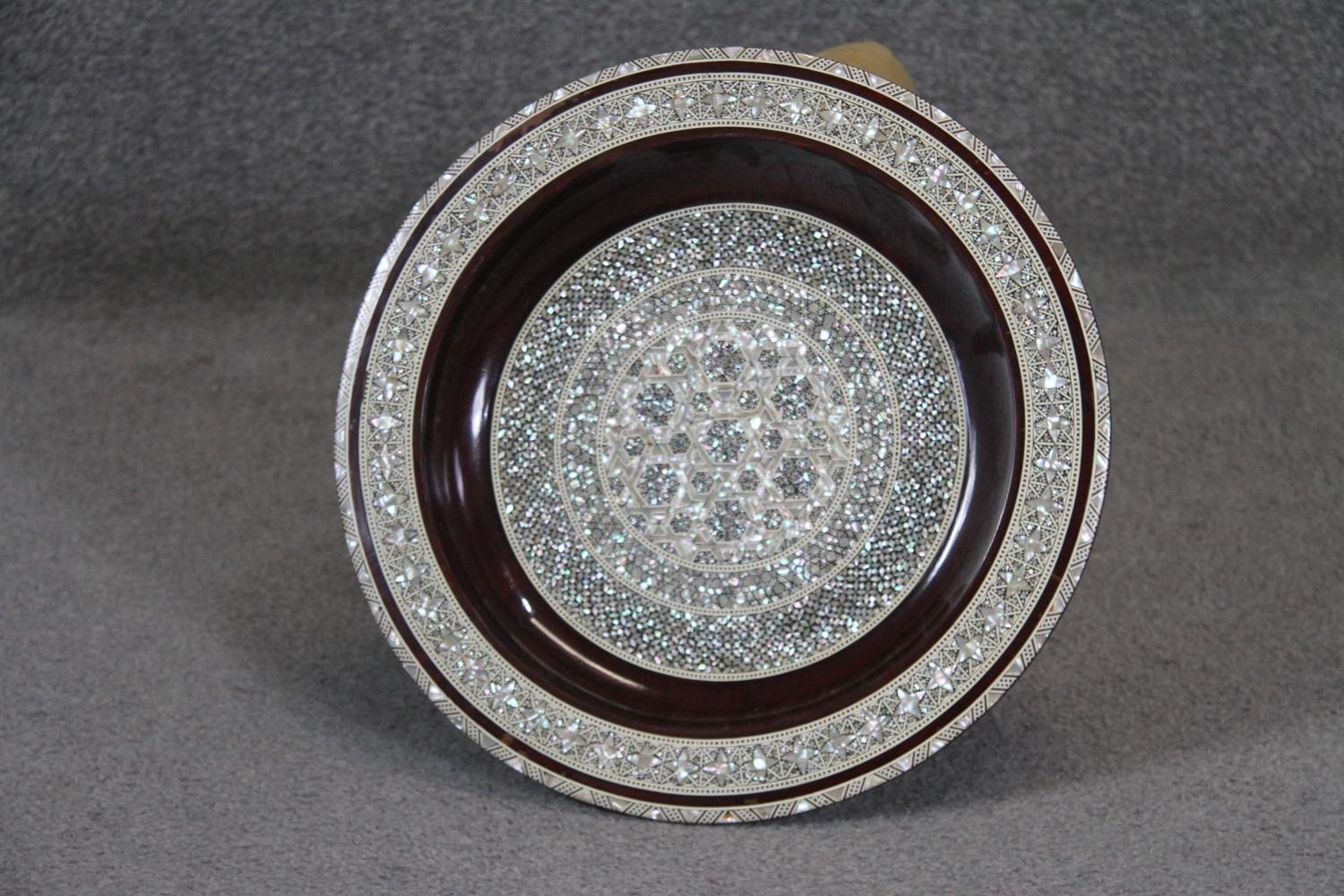 A large Egyptian micro mosaic mother of pearl and bone inlaid charger with a geometric design. Diam.
