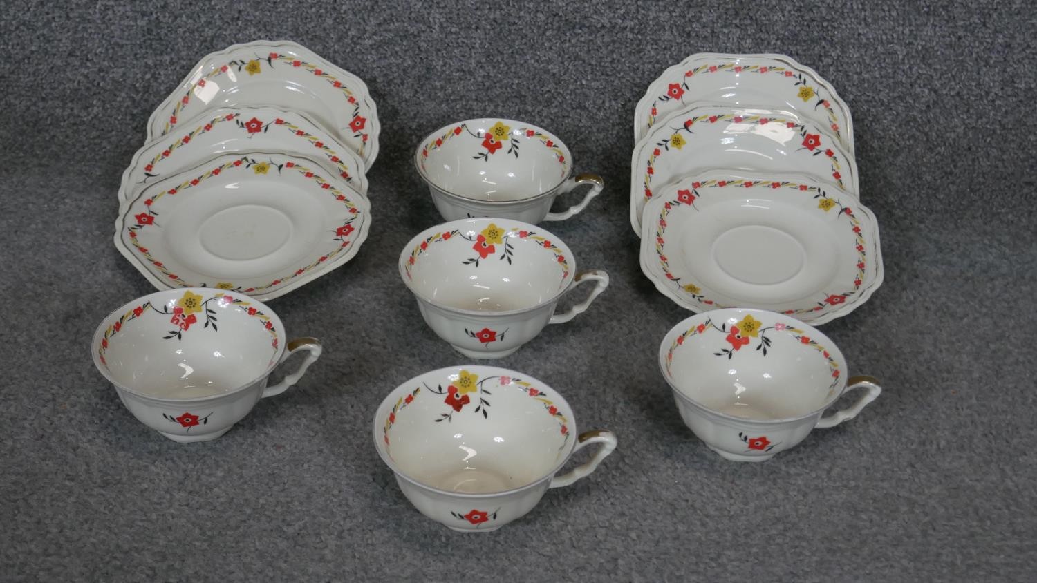 An Art Deco transfer printed floral design six person porcelain tea set (two cups missing), 11