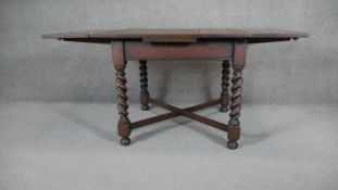 A mid century oak draw leaf table on barleytwist supports. H.73 W.153 D.91CM