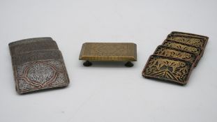 Two sets of metal Oriental buckles, one set of four with tiger motifs and the other set with a