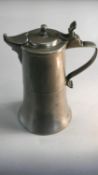 An 18th century pewter lidded flagon with engraved coat of arms with monogram and relief seal of a