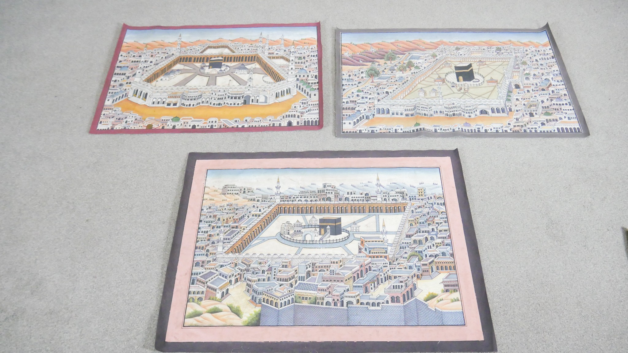 Three unframed Indian paintings on fabric of a bird's eye view of Mecca. L. 70 W. 94