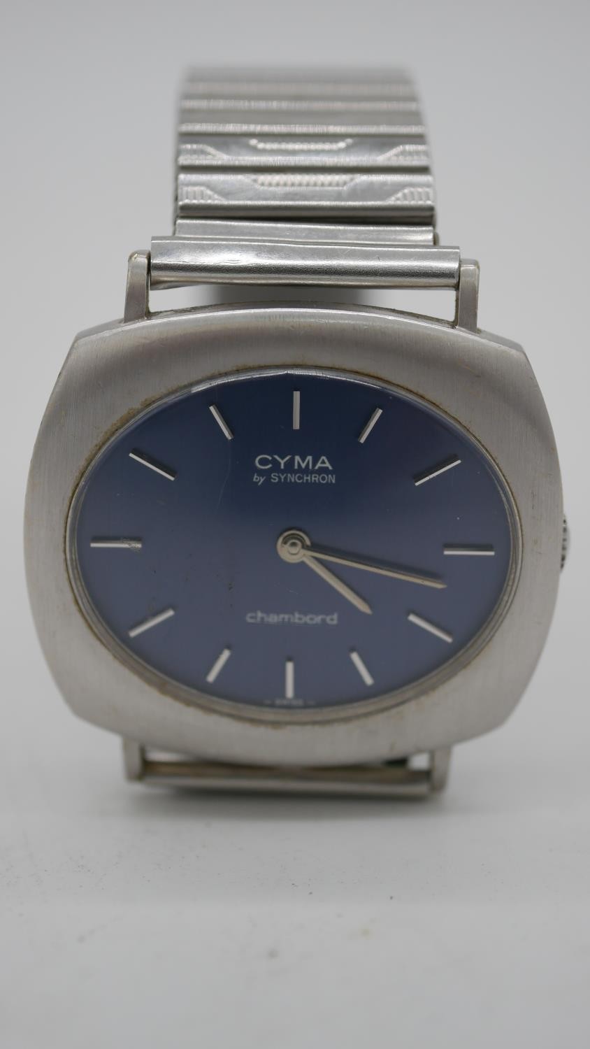 A vintage CYMA by Synchron, Chambord steel swiss watch with stretch strap and dark blue dial.