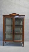 An Edwardian mahogany and satinwood strung and inlaid display cabinet with fabric lined interior