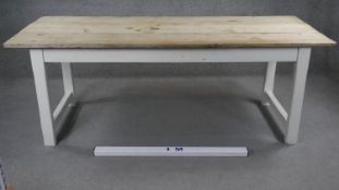 A 19th century refectory dining table with ash planked top on painted base with central frieze