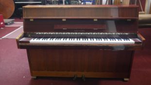 A 1970's Reid-Sohn small upright piano in lacquered teak case. h107 w148 d50