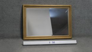 A gilt framed wall mirror with bevelled plate. H.70 W.100