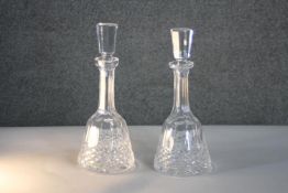 A pair of Waterford hand cut crystal decanters with diamond pattern, star cut bases and octagonal