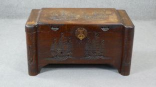 A vintage Chinese camphor wood chest with carved decoration. H. 50 W. 90 D. 46