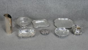 A collection of eight silver plate items. Including an Art Deco wine bottle cover, two pierced