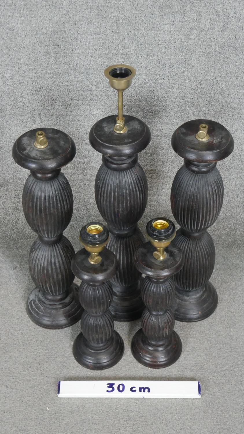 Four carved and stained table lamps with ridged bulbous design. H.53CM - Image 2 of 4