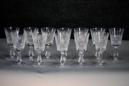 A set of twelve hand cut Waterford crystal wine glasses with star cut bases and stylised foliate