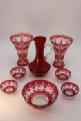 A collection of Bohemian glass. Including a pair of ruby cut to clear glass conical design vases,