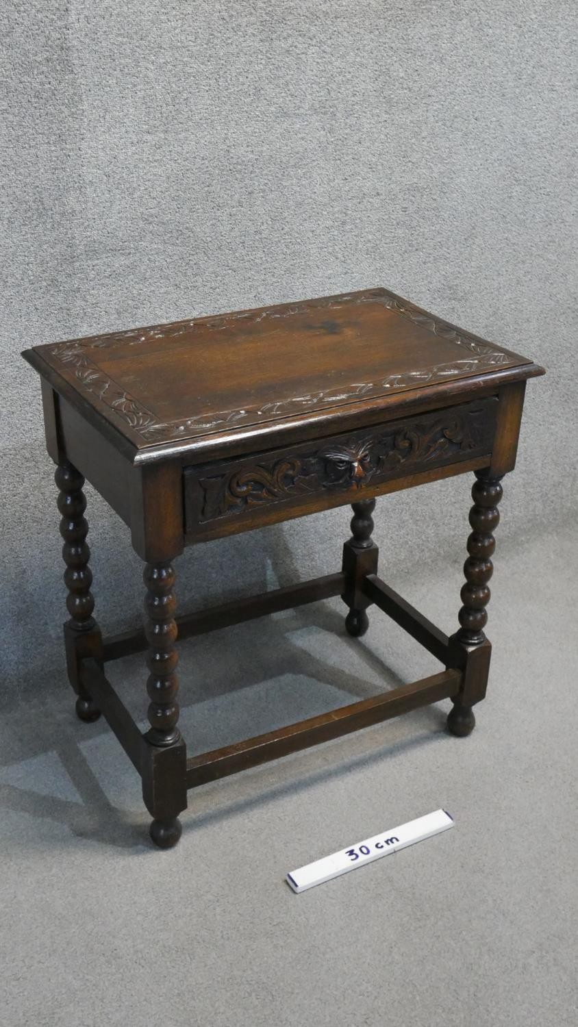 A mid century oak side table with mask carved frieze drawer on bobbin turned supports. H. 79 W. 69 - Image 2 of 5