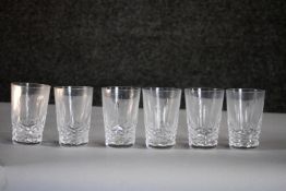 A set of six hand cut crystal glasses with stylised foliate design. H.9cm