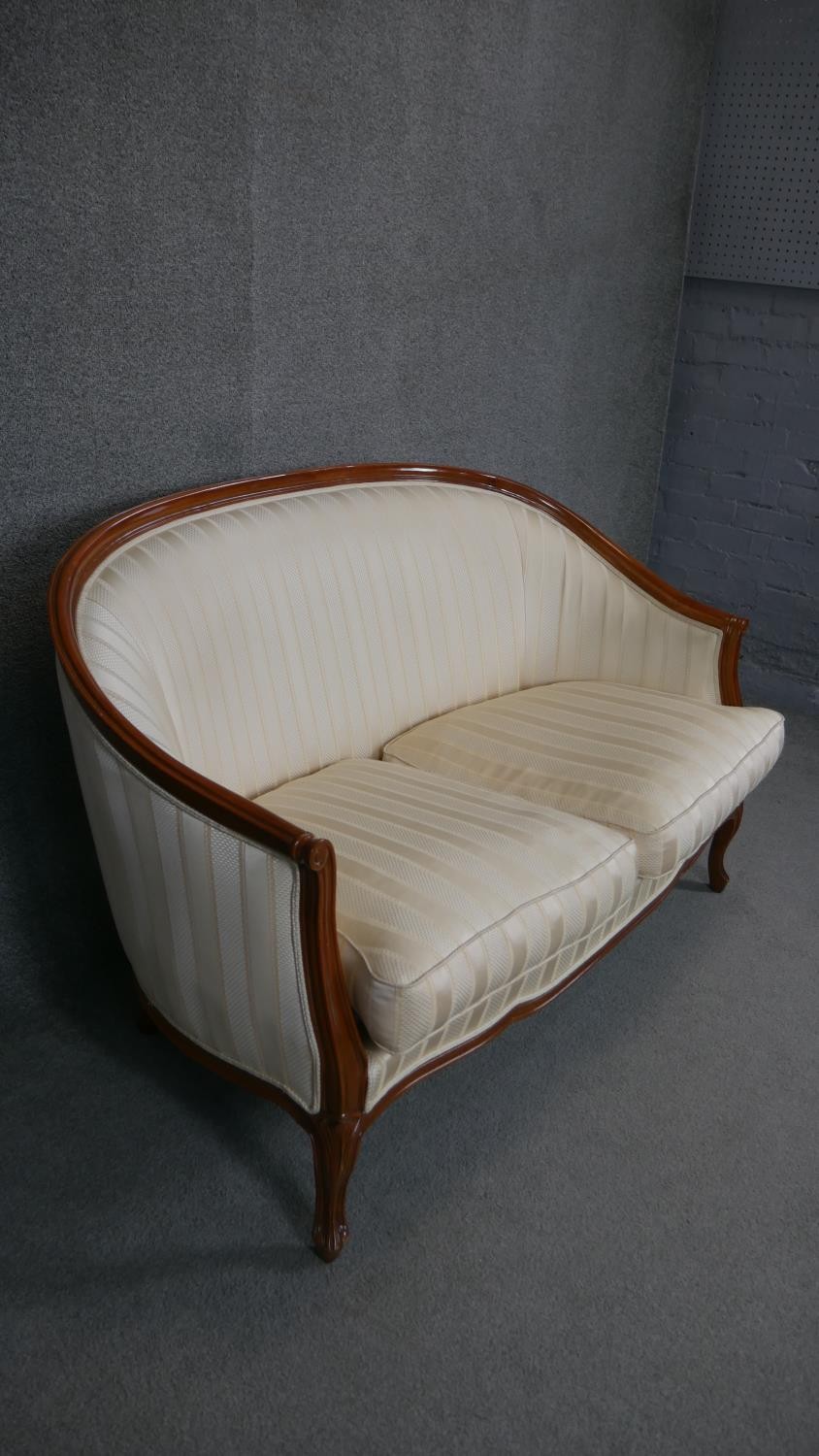 A Louis XV style two seater canape in striped upholstery on carved cabriole supports. - Image 3 of 5