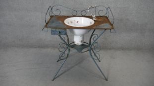 A vintage French style wrought iron washstand fitted with enamelled bowl hand decorated with