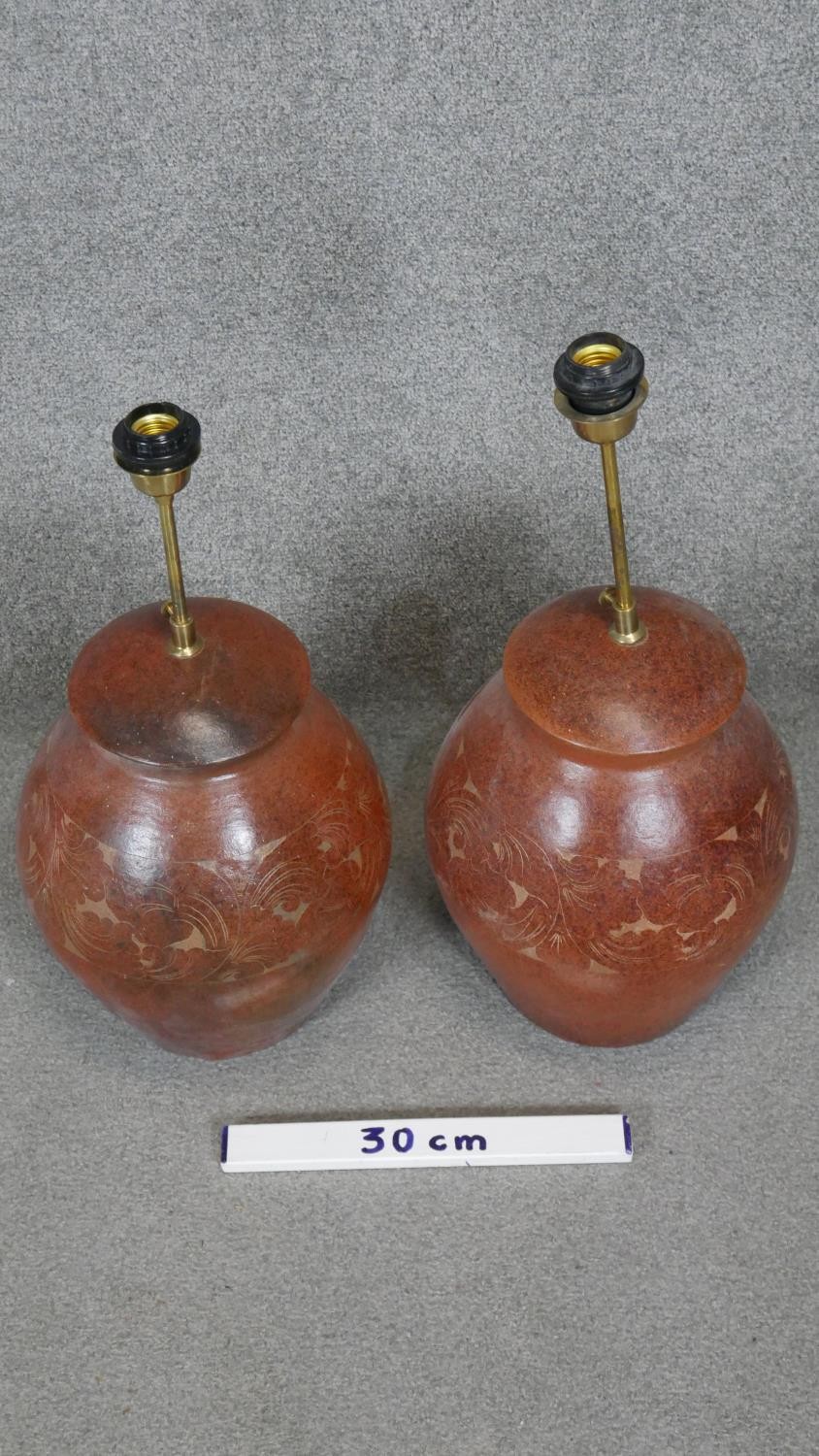 Two floral engraved terracotta effect ceramic table lamps with brass fittings. H.56CM - Image 2 of 3