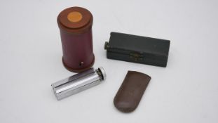A cased pistol table lighter along with a Rexcell cigarette rolling machine, a WWII convoy brass