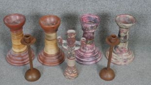 A collection of candlesticks. Including a pair of bronze effect candlesticks and various painted