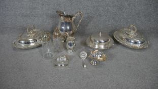 A large collection of silver plate. Including two oval lidded serving dishes with foliate design